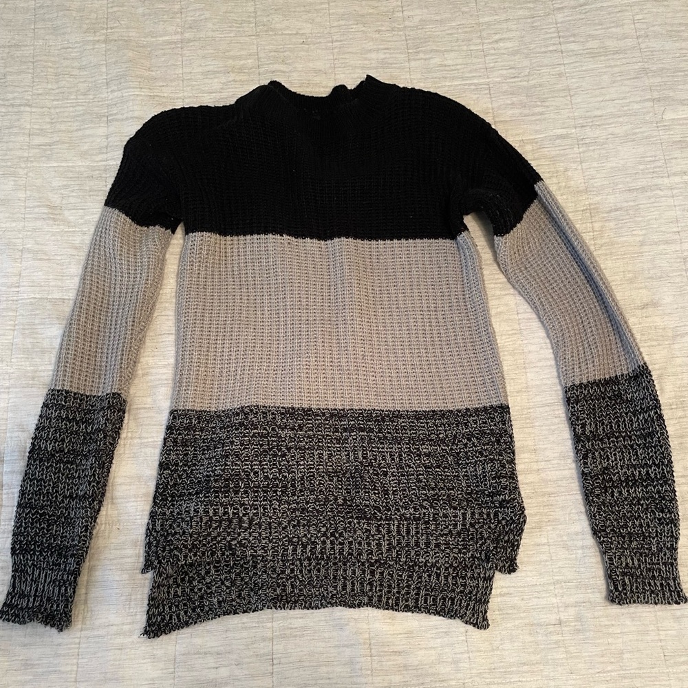 Black and grey striped sweater, slightly worn.